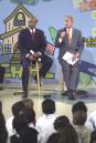 With Secretary of Education Ronald Paige by his side President Bush, right, addresses a gathering at Justina Elementary School in Jacksonville, Fla., Monday, Sept. 10, 2001. Bush is in Florida to promote his reading education program in Congress. (AP Photo/Peter Cosgrove)