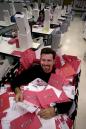 Netflix Chief Executive Officer Reed Hastings sits in a mail delivery case of thousands of DVDs at their distribution plant in San Jose, Calif., Monday, Sept. 10, 2001. Online DVD rental company Netflix is emerging as one of the Internet's rising stars that has attracted a cast of 300,000 subscribers who pay a $19.95 monthly fee to get up to three DVD rentals mailed to them. (AP Photo/Paul Sakuma)