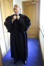 Judge Richard Casey adjusts the collar of his robe in his office at the U.S. District Courthouse Wednesday, Aug. 15, 2001, in New York. Casey, a federal judge in Manhattan who is blind, sees humor and joy while dispensing justice.  (AP Photo/Beth A. Keiser)