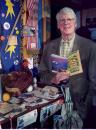 Jud Hale, editor-in-chief of The Old Farmer's Almanac, stands in his office in Dublin, N.H., Thursday Sept. 6, 2001 with the 2002 edition of North America's oldest continuously published periodical, The Old Farmer's Almanac. This year's Almanac predicts a warmer than normal year. (AP Photo/Jim Cole)