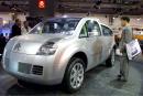 A visitor looks at French carmaker Citroen's new concept car, the C-Crosser, at the Frankfurt, Germany, International Auto Show (IAA), on Tuesday, Sept. 11, 2001, the first day of the biennial event. (AP PHOTO/Frank Rumpenhorst)