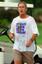 President Bush walks past reporters following a pre-dawn workout at the Longboat Key Club in Sarasota, Fla., Tuesday, Sept. 11, 2001. Bush will visit the at Emma E. Booker Elementary School later Tuesday morning. (AP Photo/Doug Mills)