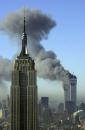 Plumes of smoke pour from the World Trade Center buildings in New York Tuesday, Sept. 11, 2001. Planes crashed into the upper floors of both World Trade Center towers minutes apart Tuesday in a horrific scene of explosions and fires that left gaping holes in the 110-story buildings. The Empire State building is seen in the foreground. (AP Photo/Patrick Sison)