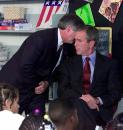 President Bush's Chief of Staff Andy Card whispers into the ear of the President to give him word of the plane crashes into the World Trade Center, during a visit to the Emma E. Booker Elementary School in Sarasota,  Fla., Tuesday, Sept. 11, 2001. (AP Photo/Doug Mills)