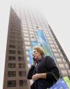 Cathleen Jones, a legal secretary for a downtown Los Angeles law firm, talks to her husband on her cellular phone after the office building where she works was closed following terrorist attacks in New York and Washington, Tuesday, Sept. 11, 2001. (AP Photo/Kevork Djansezian)