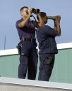 Uniformed Secret Service agents stand on the roof at the terminal of Sarasota/Bradenton International Airport while waiting for President Bush to board Air Force One Tuesday, Sept. 11, 2001in Bradenton, Fla. (AP Photo/Steve Nesius)