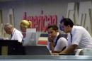 American Airlines employees work at the ticketing area at Logan International Airport in Boston, Tuesday, Sept. 11, 2001, as flights are cancelled in the wake of two planes crashing into the World Trade Center in New York earlier. One of the planes that crashed into the World Trade Center was American Flight 11, a Boeing 767 en route from Boston to Los Angeles with 81 passenger, nine flight attendants and two pilots. (AP Photo/Elise Amendola)