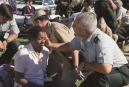 A Pentagon employee is aided outside the Pentagon Tuesday, Sept. 11, 2001 after the building took a direct, devasting hit from an aircraft in a terrorist attack. (AP Photo/Mandatory Credit, Will Morris)