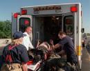 An injured person from the Pentagon is loaded into an ambulance outside the building Tuesday, Sept. 11, 2001 after the building took a direct, devasting hit from an aircraft during a terrorist attack.. (AP Photo, Mandatory Credit, Will Morris)