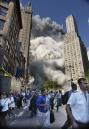 Pedestrians flee the area of the World Trade Center as the center's south tower crashes following a terrorist attack on the New York landmark Tuesday, Sept. 12, 2001. (AP Photo/Amy Sancetta)