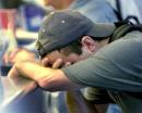 Craig McFarland of Los Angeles holds his head at the ticket counter of American Airlines Tuesday, Sept. 11, 2001, at Logan International Airport in Boston. McFarland, who exchanged his ticket, says he was supposed to leave on American Flight 11 which left Boston for Los Angeles and was reportedly highjacked and crashed into the World Trade Center in New York. (AP Photo/Michael Dwyer)