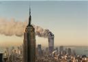 The twin towers of the World Trade Center burn behind the Empire State Building in New York, Tuesday, Sept. 11, 2001. In a horrific sequence of destruction, terrorists crashed two planes into the World Trade Center and the twin 110-story towers collapsed. Explosions also rocked the Pentagon and the State Department and spread fear across the nation.  (AP Photo/Marty Lederhandler)