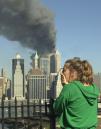 A woman reacts to a third explosion at the World Trade towers, while observing from the Brooklyn Promenade which provides a view of the Manhattan skyline, Tuesday, Sept. 11, 2001, in New York. In a horrific sequence of destruction, terrorists hijacked two airliners and crashed them into the World Trade Center in a coordinated series of attacks. (AP Photo/Kathy Willens)