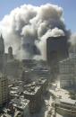 Smoke rises into the skyline after the bombing of the World Trade Center Towers, Tuesday, Sept. 11, 2001 in New York. In a horrific sequence of destruction, terrorists hijacked two airliners and crashed them into the World Trade Center in a coordinated series of attacks that brought down the twin 110-story towers. (AP Photo/Suzanne Plunkett)