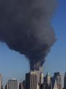 Plumes of smoke pour from the World Trade Center buildings in New York, Tuesday, Sept. 11, 2001, in this photo taken from the Brooklyn borough. Two planes crashed into the upper floors of both World Trade Center towers minutes apart in what President Bush said was an apparent terrorist attack, blasting fiery, gaping holes in the 110-story buildings. (AP Photo/Mark D. Phillips)