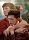 Brenda Parker, left, comforts her mother Shirley Pendleton as they watch the collapse of the World Trade Center on television  Tuesday, Sept. 11, 2001, at the Oakland International airport in Oakland, Calif. Pendleton and Parker, both of Clinton, Ark., were grounded at the Oakland Airport en route to Arkansas due to a national FAA flight travel ban. (AP Photo/Ben Margot)