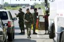 Armed military police check incoming cars and trucks trying to enter Tinker Air Force Base in Oklahoma City, Tuesday, Sept. 11, 2001. The base was the highest level of security, after Tuesday morning's attacks in Washingon and in New York. (AP Photo/J. Pat Carter)