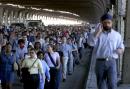 Pedestrians make their way across the Queensboro Bridge as they leave Manhattan after terrorists crashed two airliners into the World Trade Center, Tuesday, Sept. 11, 2001, bringing down the 110-story twin towers. (AP Photo/Ron Frehm)