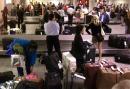 Passengers wait to claim their bags at the Raleigh-Durham International Airport, in Morrisville, N.C., Tuesday, Sept. 11, 2001, after federal authorities grounded all flights amid reports that hijacked planes had been crashed into targets in New York City and Washington. (AP Photo/Bob Jordan)