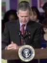 President Bush bows his head for a moment of silence following the plane crashes into the World Trade Center, during a visit to the Emma E. Booker Elementary School in Sarasota,  Fla., Tuesday, Sept. 11, 2001. (AP Photo/Doug Mills)