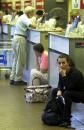 Passengers wait at Detroit Metropolitan Airport in Romulus, Mich., Tuesday, Sept. 11, 2001, after the terrorism attack on New York and Washington. All U.S. airports are closed down in the wake of the attack. (AP Photo/Carlos Osorio)