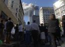 Pedestrians in lower Manhattan watch smoke rise from the World Trade Tower Tuesday, Sept. 11, 2001, after an early morning terrorist attack on the New York landmark. (AP Photo/Amy Sancetta)