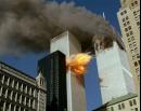 Smoke pours off one of the towers of the World Trade Center as flames explode from the second one as it is struck by a plane Tuesday, Sept. 11, 2001, after terrorists crashed planes into the buildings.  The attack collapsed both buildings. (AP Photo/Chao Soi Cheong)