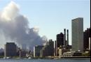 The United Nations building stands tall at the right as smoke billows from the World Trade Center in lower Manhattan, Tuesday, Sept. 11,2001. Terrorists crashed  two airliners into the both 110-story towers bringing them down.  (AP Photo/Ron Frehm)