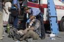 An emergency worker treats a victim near the World Trade Center in New York after terrorists crashed two airliners into the twin 110-story towers Tuesday, Sept. 11, 2001. Both towers collapsed following the crashes. (AP/Photo/Amy Sancetta)