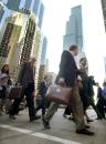 With the Sears Tower behind them, pedestrians head away from their offices in downtown Chicago, Tuesday morning, Sept. 11, 2001, in Chicago. Many Chicago buildings, including the Sears Tower, were shut down as security measures in response to the attack at the World Trade Center in New York.(AP Photo/M. Spencer Green)