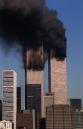 Smoke rises from the the twin towers of the World Trade Center in New York, Tuesday, Sept. 11, 2001. Planes crashed into the upper floors of both World Trade Center towers minutes apart Tuesday morning in a horrific scene of explosions and fires that left gaping holes in the 110-story buildings. (AP Photo/Brad DeCecco)