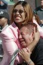 RETRANSMITTED TO PROVIDE ALTERNATE CROP -- Two women hold each other as they watch the World Trade Center burn following a terrorist attack on the twin skyscrapers in New York Tuesday, Sept. 11, 2001.  Terrorists crashed two planes into the World Trade Center and the twin 110-story towers collapsed Tuesday morning. (AP Photo/Ernesto Mora)