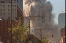 One of the World Trade Center buildings collapses shortly after two planes crashed into the upper floors of both towers in New York, Tuesday, Sept. 11, 2001. (AP Photo/Pedro J. Cardenas)