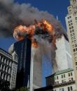 Smoke, flames and debris erupts from one of the World Trade Center towers as a plane strikes it Tuesday, September 11, 2001.  The first tower was already burning following a terror attack minutes earlier.   Terrorists crashed  planes into the two buildings and collapsed both towers. (AP Photo/Chao Soi Cheong)