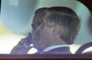 President Bush, left, talks on a cell phone as he arrives with White House Chief of Staff Andrew Card in the presidential limousine on their way to board Air Force One Tuesday, Sept. 11, 2001 at Sarasota/Bradenton International Airport in Bradenton, Fla. (AP Photo/Steve Nesius)