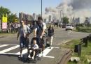 Residents of New York City walk away from Liberty State Park in Jersey City, N.J., Tuesday,  Sept. 11, 2001, after being evacuated by ferry from the area of the World Trade Center. Smoke from the attack can be seen in background.  Both towers of the center collapsed Tuesday after jets crashed into them Tuesday morning. (AP Photo/Mike Derer)