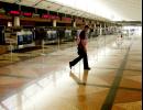 A Denver police officer walks through the United Airlines ticketing area at Denver International Airport, Tuesday, Sept. 11, 2001, after the airport was closed. All domestic flights in the United States were grounded after Tuesday morning's attacks in New York and in Washington.  (AP Photo/Ed Andrieski)