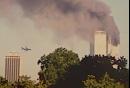 A plane approaches New York's World Trade Center moments before it stuck the tower at left, as seen from downtown Brooklyn, Tuesday, Sept. 11, 2001. In an unprecedented show of terrorist horror, the 110-story towers collapsed in a shower of rubble and dust after two hijacked airliners carrying scores of passengers slammed into them. (AP Photo/William Kratzke)