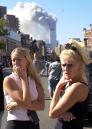 Judith Puckett, left, of New York, and Janie Payne, of Wichita, Kansas,  react as smoke erupts from one of the World Trade Center towers after terrorists crashed  airplanes into both towers Tuesday, September 11, 2001.  (AP Photo/Matt Moyer)