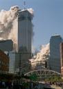 Smoke billows from the top of one of the twin towers of the World Trade Center in New York, Tuesday, Sept. 11, 2001, as a cloud of smoke and dust rises from the other tower as it collapses. Terrorists crashed two hijacked airliners into the World Trade Center and brought down the twin 110-story towers Tuesday morning. (AP Photo/David Karp))