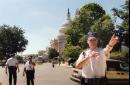 A Capitol Hill police officer directs visitors away Tuesday, Sept. 11, 2001 after the Capitol was evacuted and closed down after attacks by aircrafts in New York and at the Pentagon. (AP Photo/Ron Thomas)