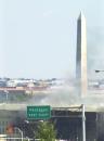 With the Washington Monument in the background, smoke billows from the Pentagon Tuesday, Sept. 11, 2001 after the building took a direct, devastating hit from an aircraft. (AP Photo/Linda Spillers)