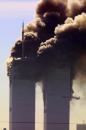 Smoke billows from the twin towers of the World Trade Center in New York after planes crashed into each tower Tuesday, Sept. 11, 2001  This photo was taken from the New Jersey Turnpike near Kearny.  (AP Photo/Gene Boyars)