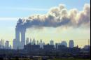 As seen from the New Jersey Turnpike near Kearny, N.J., smoke billows from the twin towers of the World Trade Center in New York after airplanes crashed into both towers Tuesday, Sept.11, 2001. (AP Photo/Gene Boyars)