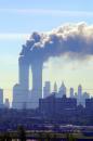 Smoke billows from the twin towers of the World Trade Center in New York after planes crashed into each tower Tuesday, Sept. 11, 2001  This picture was made from the New Jersey Turnpike in the Kearny, NJ area.  (AP Photo/Gene Boyars)