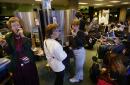 From left, Rosalie Devereaux from Issaquah, Wash., June Pazik of Sun City, Fla., and Carol Pazik, from Washington, D.C., make calls after their flights were grounded at Seattle-Tacoma International Airport on Tuesday, Sept. 11, 2001. The Federal Aviation Administration ordered all outbound flights grounded following the fiery twin disaster at the World Trade Center. (AP Photo/Cheryl Hatch)