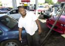 After waiting for more than an hour, Edward Smith of Indianapolis fills his car up with gas Tuesday, Sept. 11, 2001, in Indianapolis. (AP Photo/Darron Cummings)