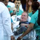 A New York City firefighter is brought into St. Vincent's Hospital following the collapse of the World Trade Center towers Tuesday, Sept. 11, 2001 in New York. (AP Photo/Diane Bondareff)