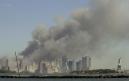 The Statue of Liberty, right, stands at the entrance to New York Harbor as the twin towers of the World Trade Center burn in New York City in this view from Jersey City, N.J., Tuesday, Sept. 11, 2001, after the attacks on the towers and at the Pentagon in Washington. (AP Photo/Mike Derer)