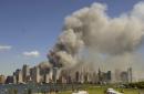 The World Trade Center continues to burn Tuesday afternoon, Sept. 11, 2001, in New York City in this view from Liberty State Park in Jersey City, N.J., after the attacks on the towers and at the Pentagon in Washington.  (AP Photo/Mike Derer)